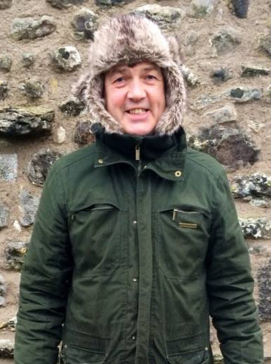 Colin, founder of St. John’s Carpets, smiling and standing proudly in front of a customer's home