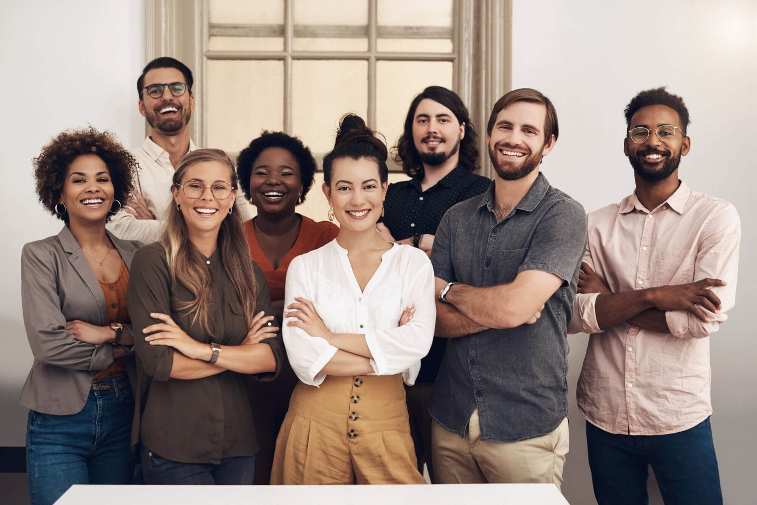A group of people standing side by side, posing for a group photo.